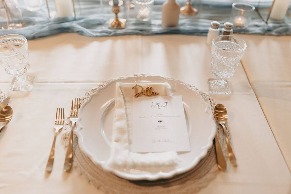 Place setting with gold utensils and white plate